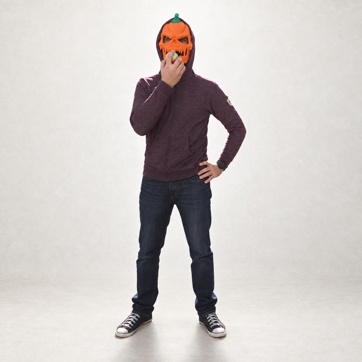 Full-body view of a person wearing the pumpkin skull mask
